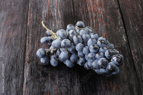 black grapes on wooden background