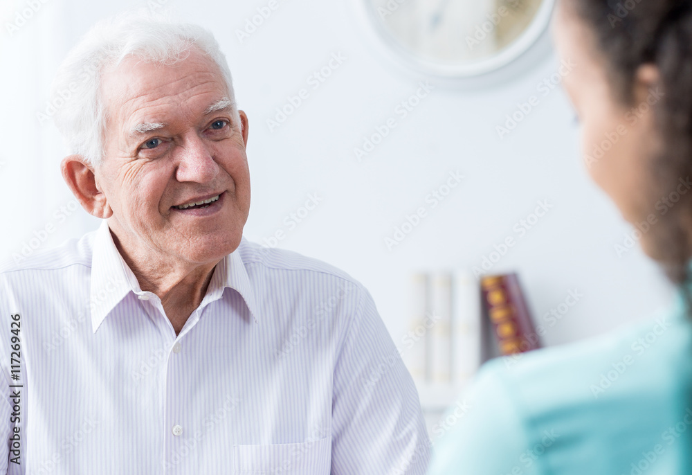 Senior man talking to caregiver Senior man talking to caregiver