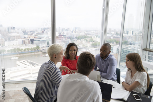 Group Of Five Business People Meeting In High Rise Office