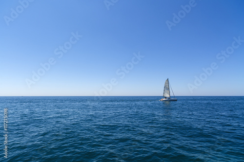 Racing yacht in the Mediterranean sea on blue sky background