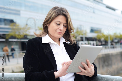 Portrait of business woman using her tablet.