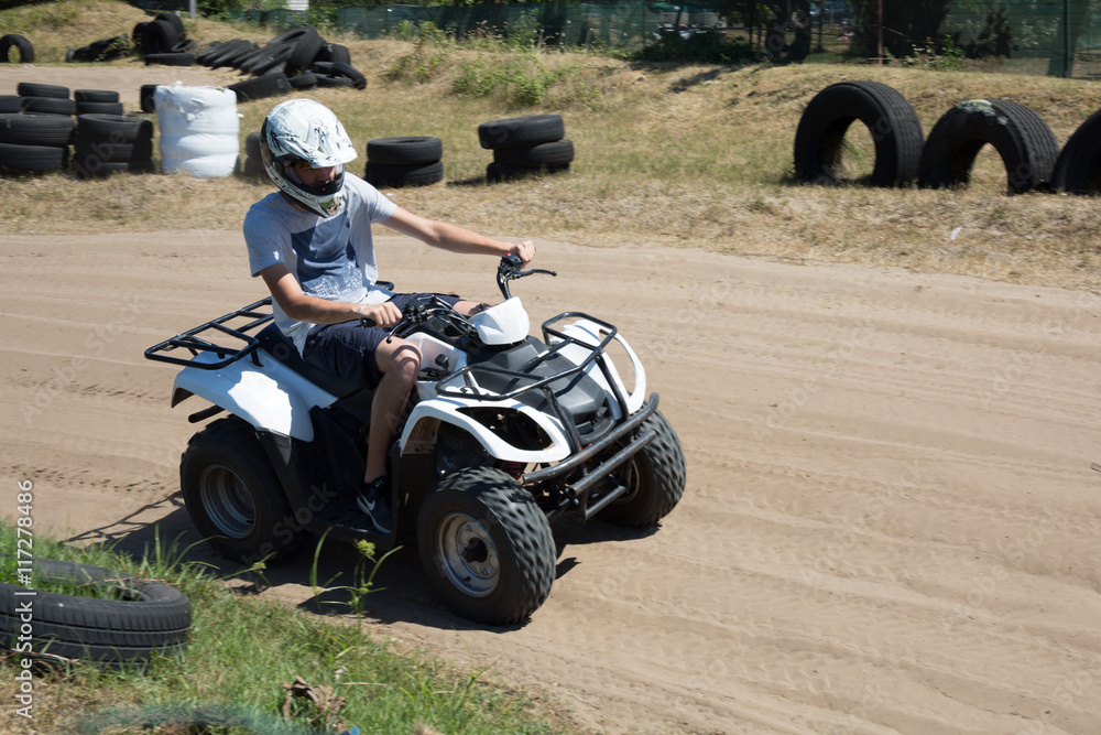 Man or young boy is driving a quad
Man or young boy is driving a quad