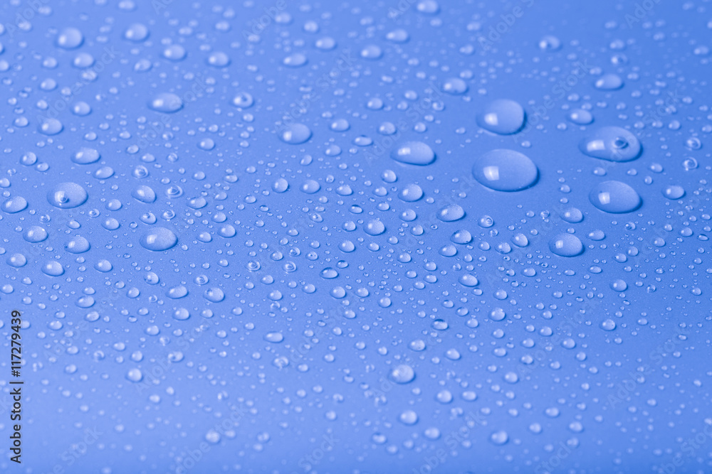 Drops of water on a color background. Blue. Shallow depth of fie Drops of water on a color background. Blue. Shallow depth of fie