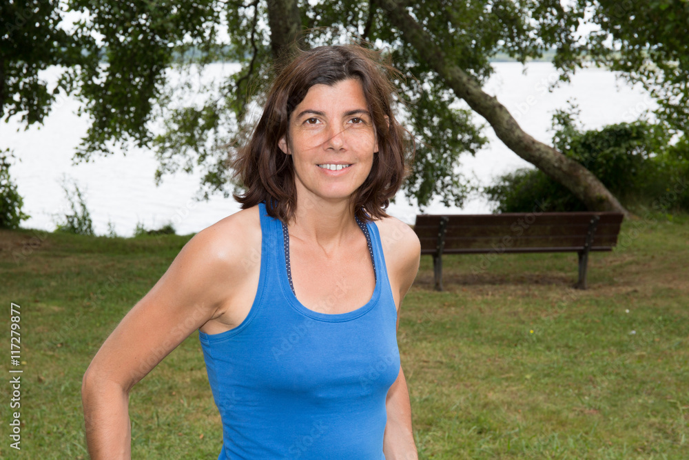 Attractive woman middle aged enjoying outdoors. Clear sunny spring day with blue sky. Attractive woman middle aged enjoying outdoors. Clear sunny spring day with blue sky.