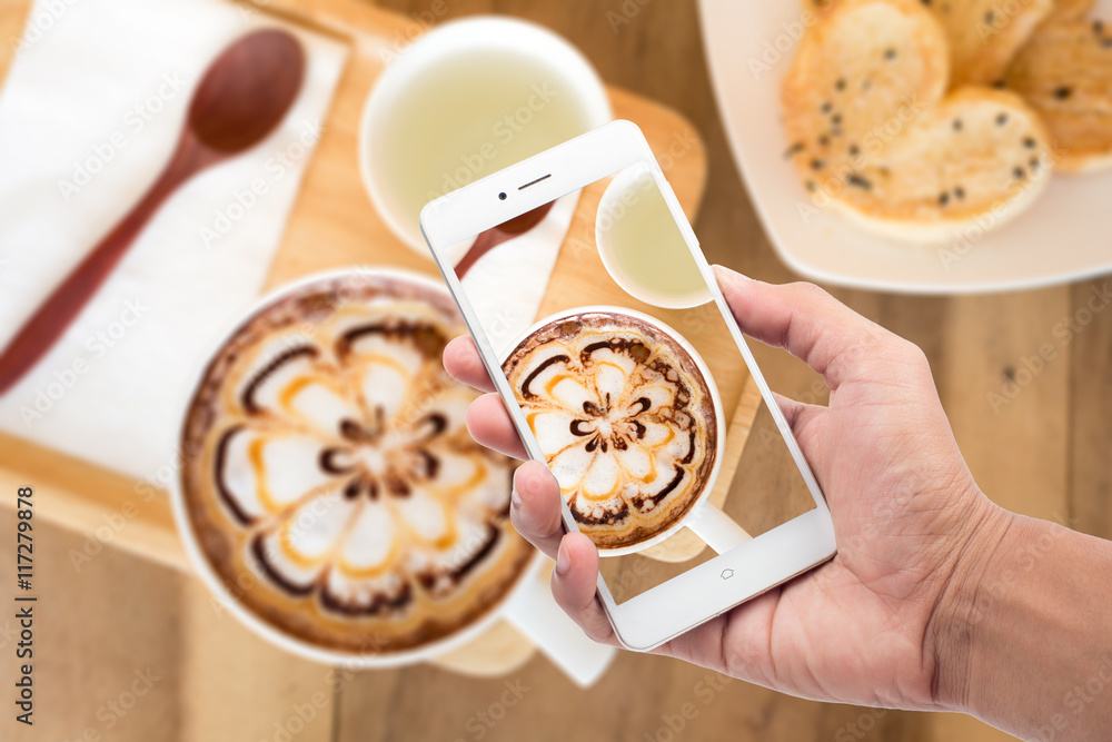 A cup of coffee with flower latte art on top and bread heart and hot pandan juice. A cup of coffee with flower latte art on top and bread heart and hot pandan juice.