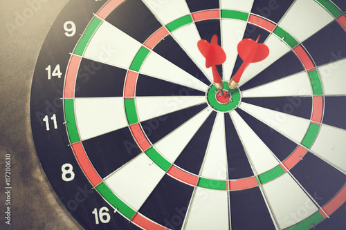 Darts accurately and perfectly hit the winning red spot on board
