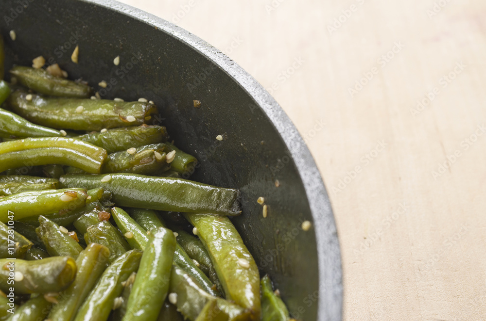 Fried green beans with garlic and sesame. Juicy food background Fried green beans with garlic and sesame. Juicy food background