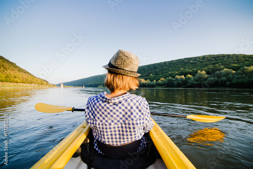 Caucasian woman is relaxing in kayak on the river. Ukraine. © iradzvonkovska