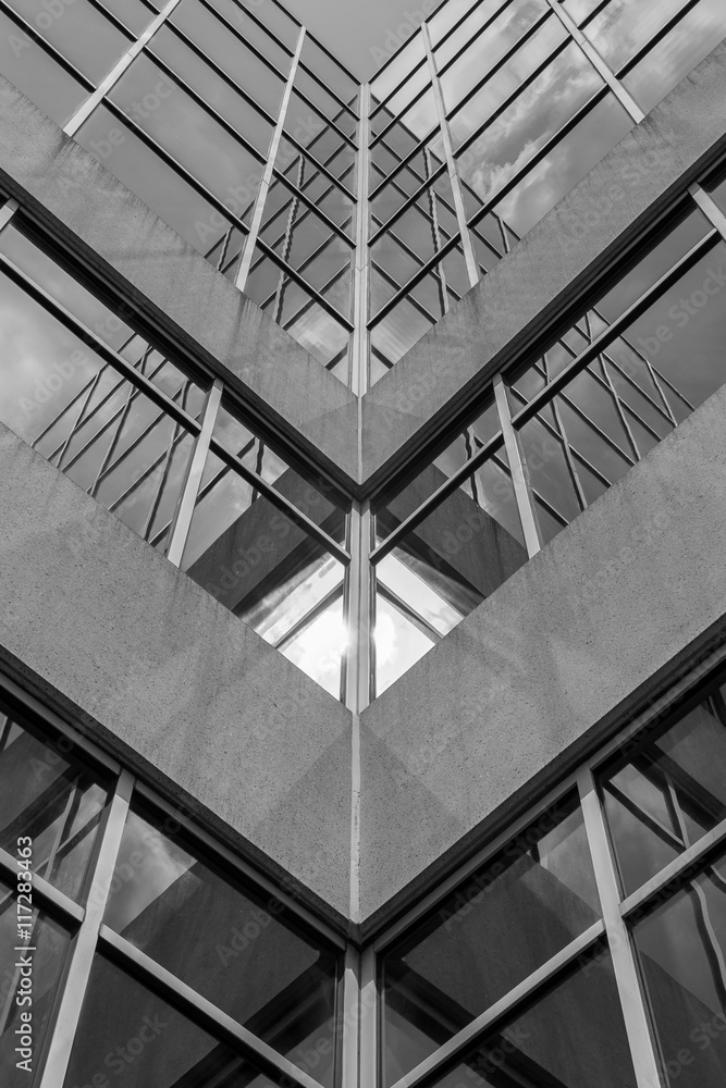 Urban Geometry, looking up to building. Modern architecture black and white, concrete and glass.  Abstract architectural design. Inspirational, artistic image BW. Artistic image and point of view. - obrazy, fototapety, plakaty 