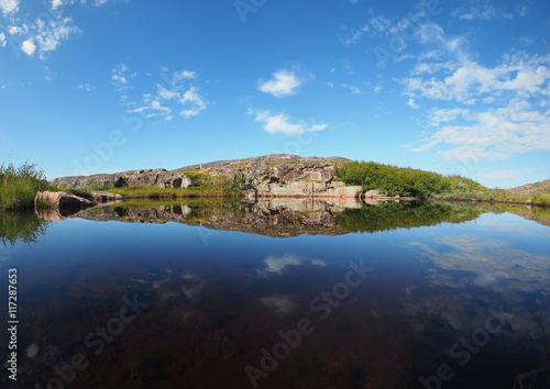 reflection in the lake. The coast of the Barents Sea