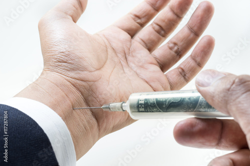 Cash injection.businessman hand with syringe money dollar inject