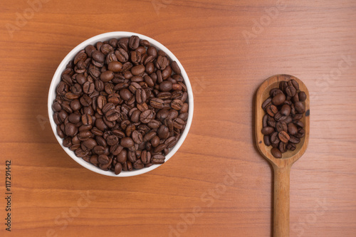 Coffee beans into a bowl and spoon. Coffea arabica