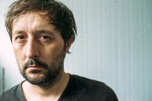 Portrait od miserable and tired adult man photo