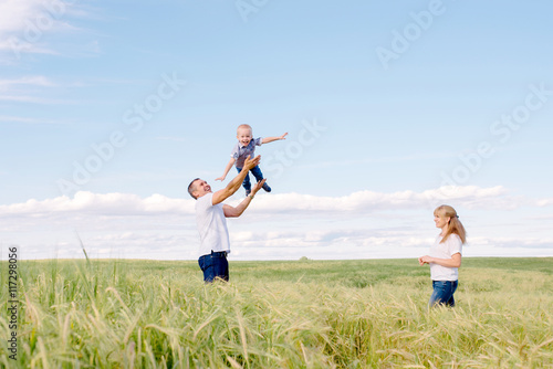 parents play with the son outdoors