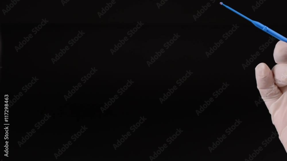 Laboratory doctor hands with sterile gloves using inoculation loop to ...