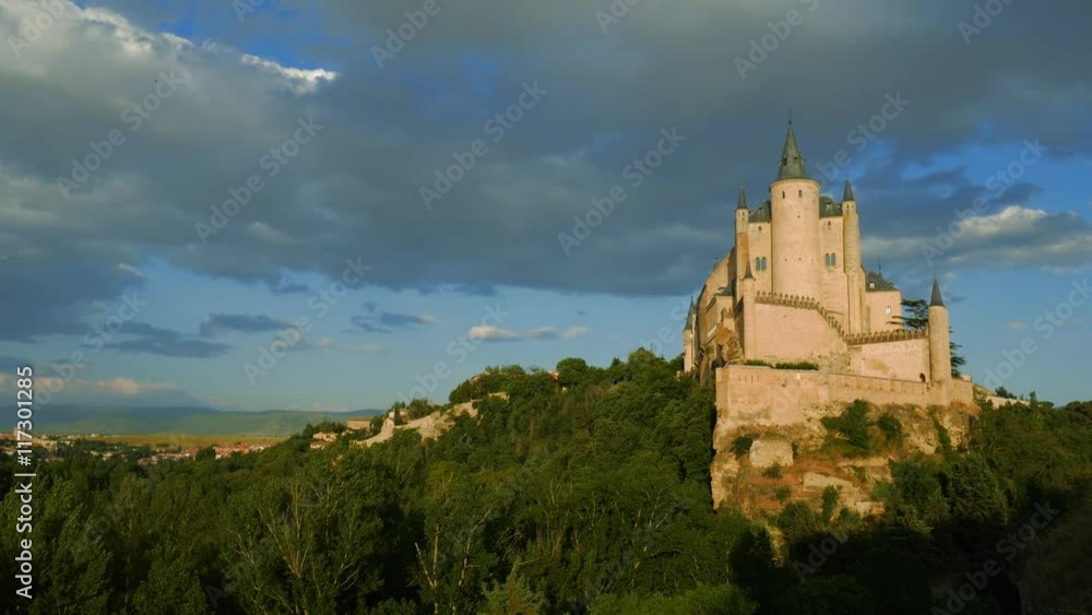 Middle age castle, romantic medieval fortress with perfect evening colored sunset light and beautiful clouds. The spanish castle Alcazar of Segovia, in Castilla y Leon, Spain Middle age castle, romantic medieval fortress with perfect evening colored sunset light and beautiful clouds. The spanish castle Alcazar of Segovia, in Castilla y Leon, Spain