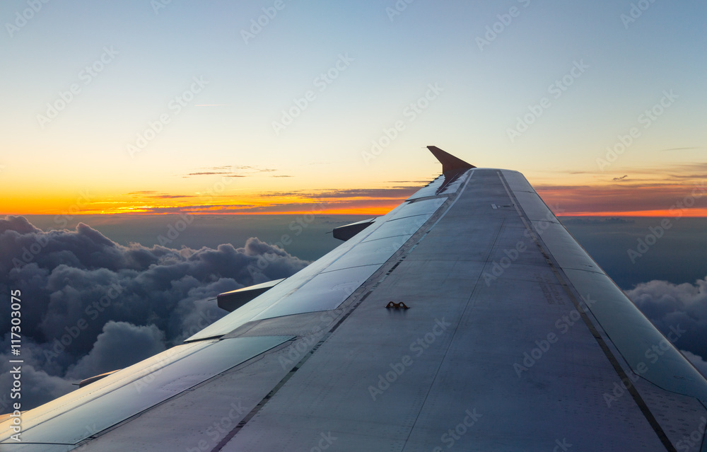 Wing of an airplane in the sunset Wing of an airplane in the sunset