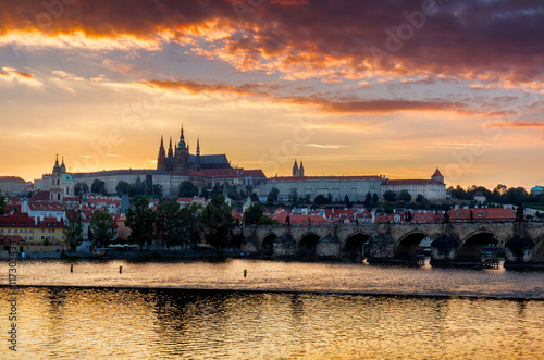 Cityscape of Prague with Castle and Charles Bridge at dramatic sunset, Czech Republic