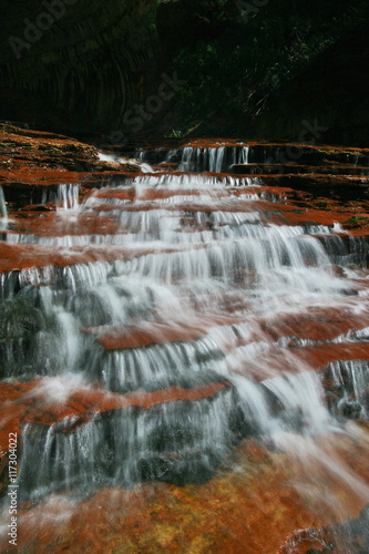 Water cascading over red rock in Zion National Park