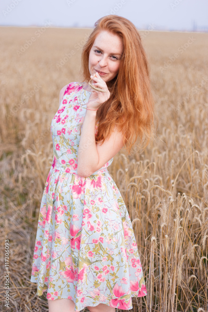 Redhair girl in dress and hat at wheat field Redhair girl in dress and hat at wheat field