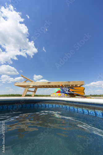 Chaise lounge by the pool . photo