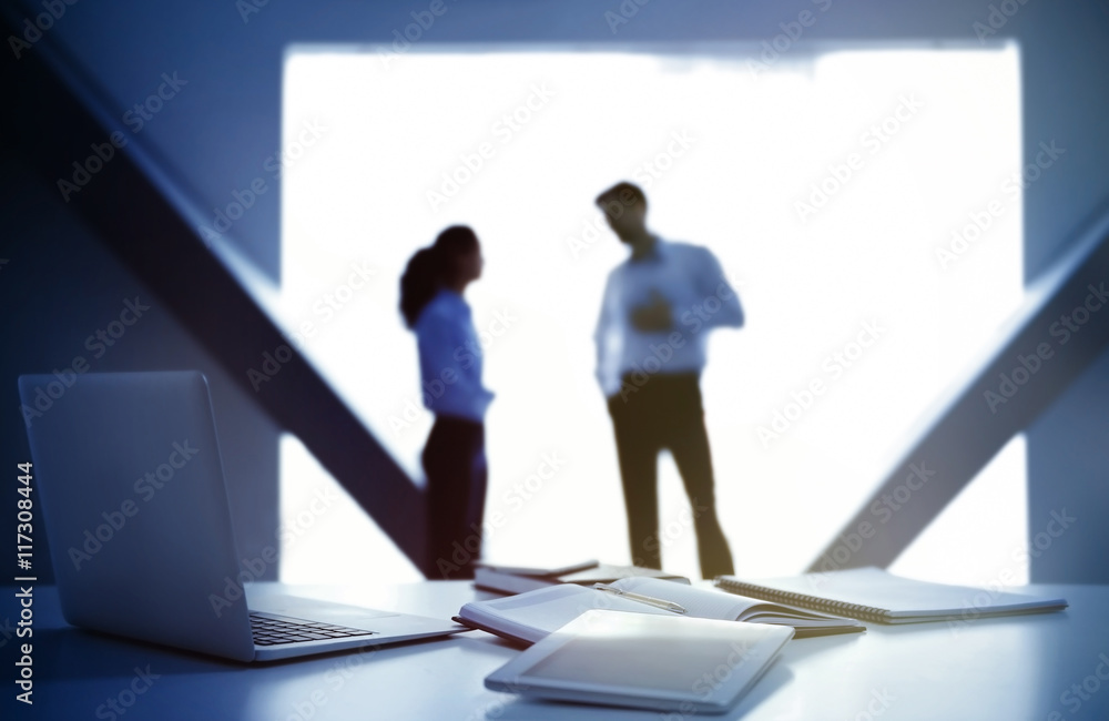 Workplace with laptop and documents on conference background Workplace with laptop and documents on conference background