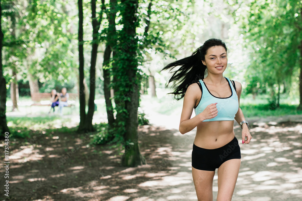 Beautiful sports girl runs in park Beautiful sports girl runs in park
