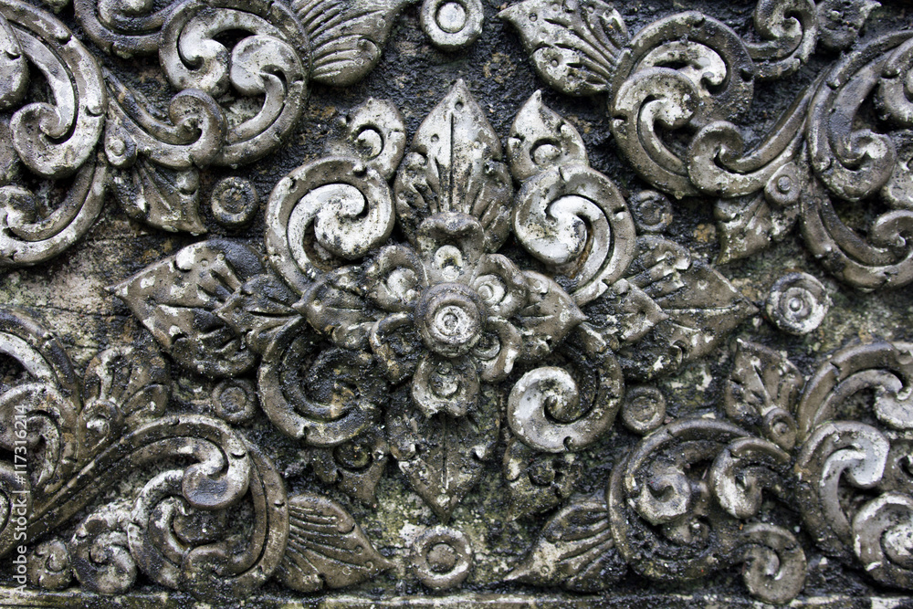 The old White stucco design of native thai style on the Wall