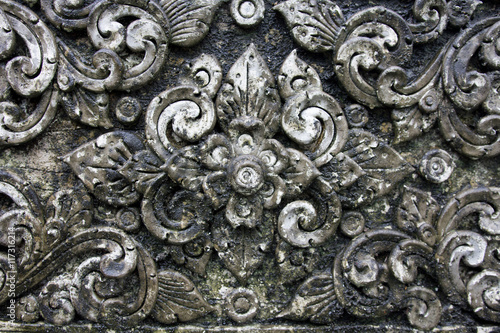 The old White stucco design of native thai style on the Wall