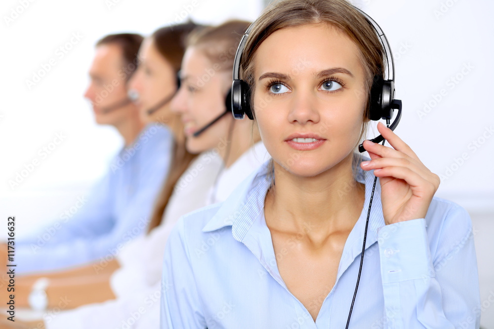 Young beautiful business woman in headset. Call center operator. Young beautiful business woman in headset. Call center operator.