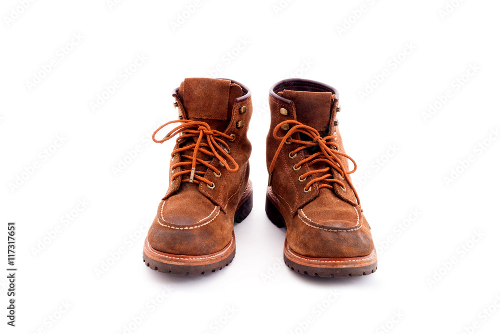 Pair of old yellow working boots Isolated on white background Pair of old yellow working boots Isolated on white background