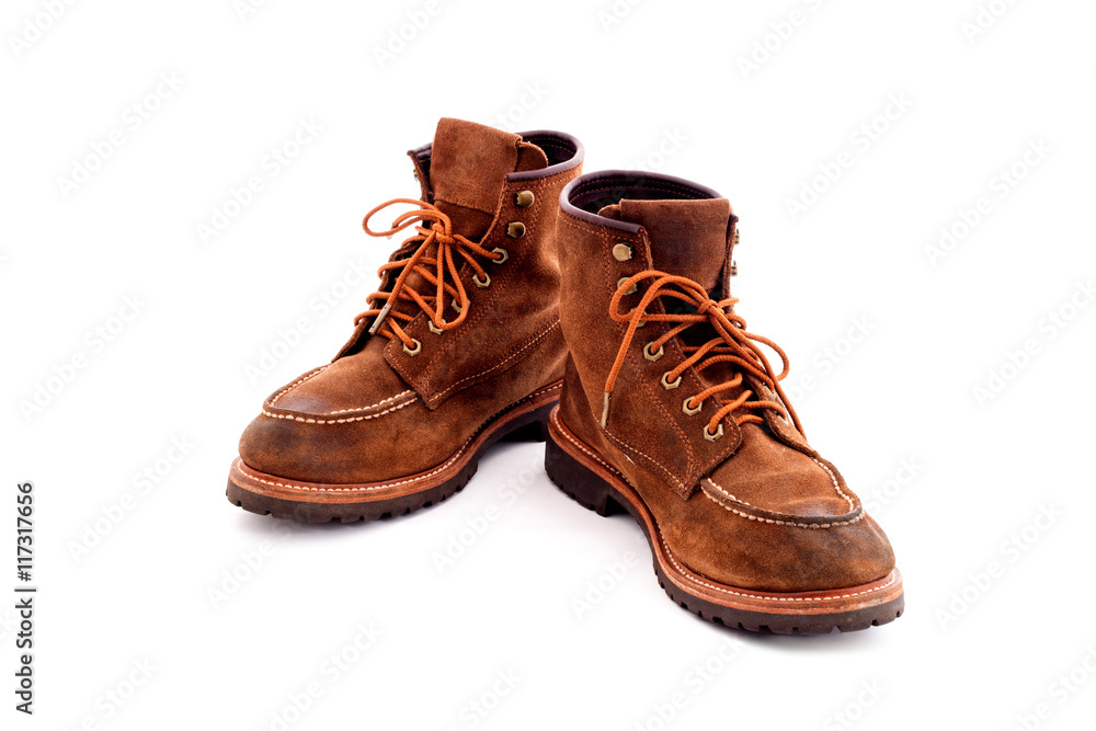 Pair of old yellow working boots Isolated on white background Pair of old yellow working boots Isolated on white background