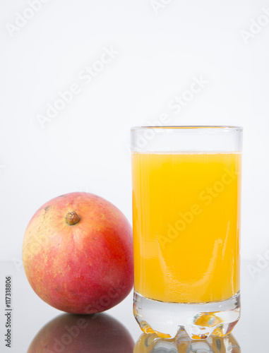 Glass with mango juice and fruit.
