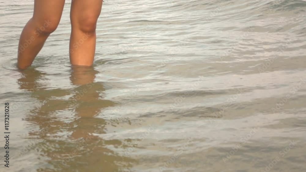 Slow motion of young women kick sea wave
Slow motion of young women kick sea wave
