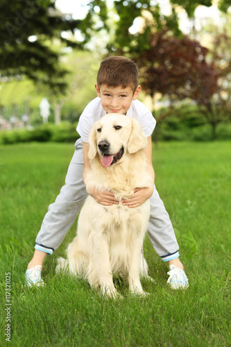 Small boy and cute dog in park