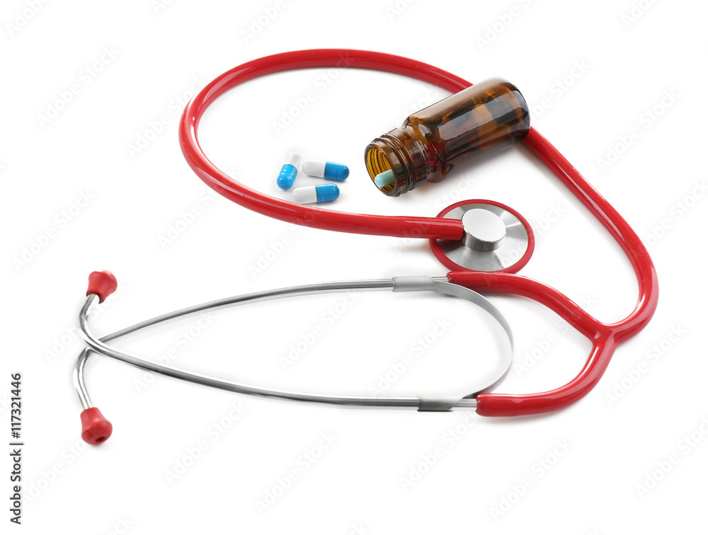 Stethoscope with colourful pills isolated on white Stethoscope with colourful pills isolated on white