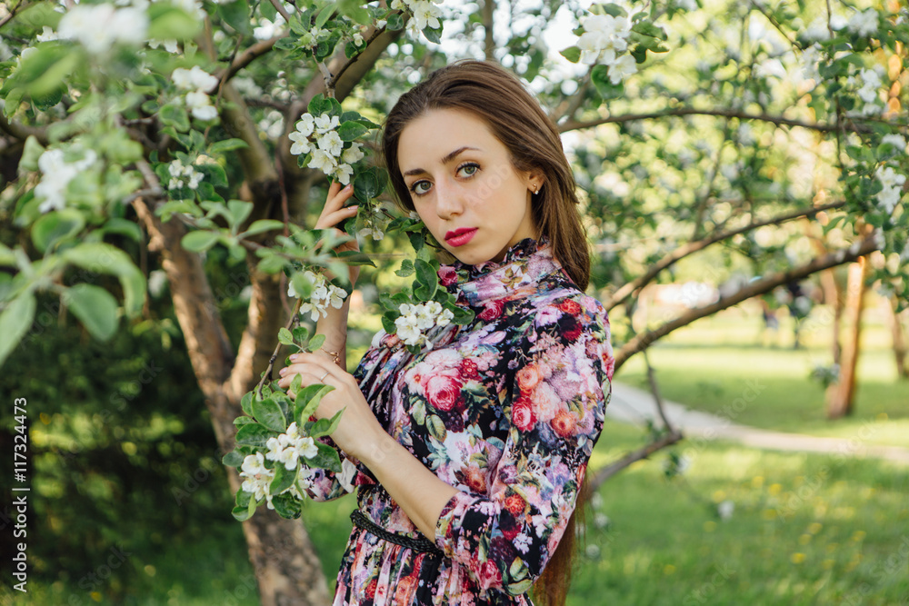 Beautiful young woman standing near the apple tree. Beautiful young woman standing near the apple tree.