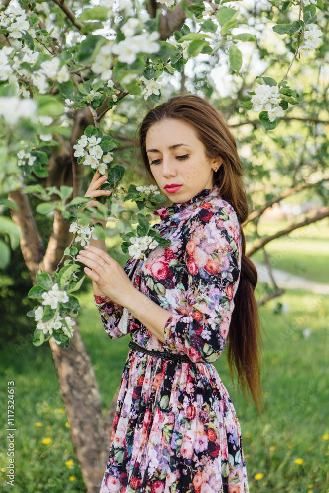 Beautiful young woman standing near the apple tree. Beautiful young woman standing near the apple tree.