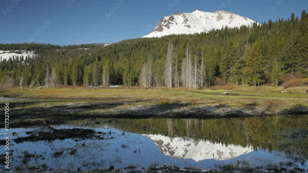 Early morning, locked down view of Lassen Peak reflecting in Hat Lake, in Lassen Volcanic National Park, California. Early morning, locked down view of Lassen Peak reflecting in Hat Lake, in Lassen Volcanic National Park, California.