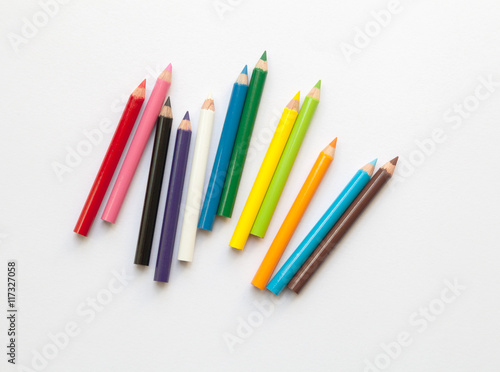 Bunch of fun mini colored pencils isolated on white. Group of wooden pencils photo