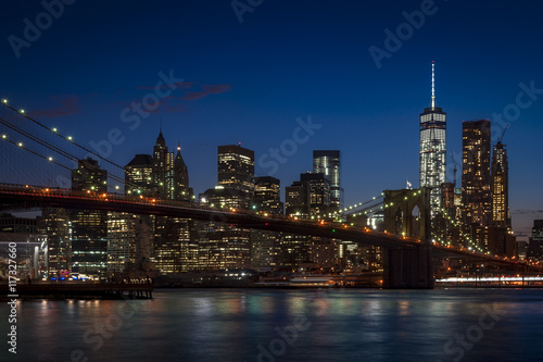 Panorama of Brooklyn Bridge and Manhattan skyline on a clear night