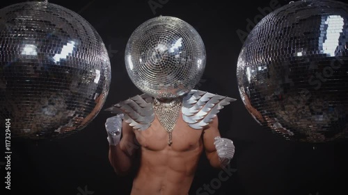 muscular man with disco ball head dancing photo