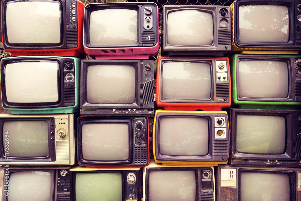 Pattern wall of pile colorful retro television (TV) - vintage filter effect style.