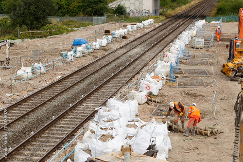 ILKESTON, ENGLAND - AUGUST 1: Construction workers on site next to a section of railway track. In Ilkeston, Derbyshire, England. On 1st August 2016. photo