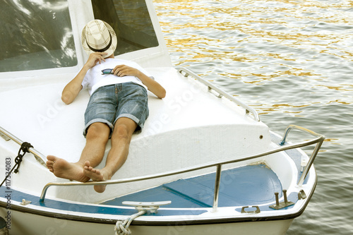 man holiday on the yacht lying at sunset in summer