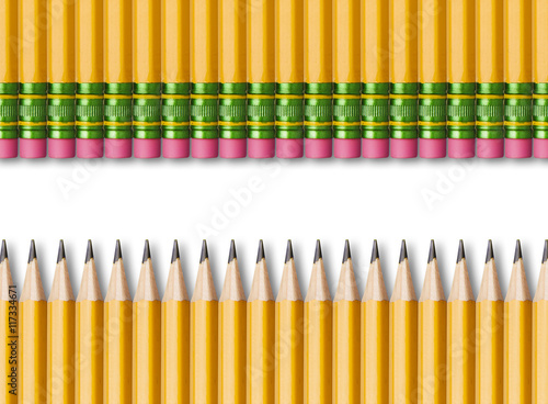 Row of yellow pencils isolated on white background photo