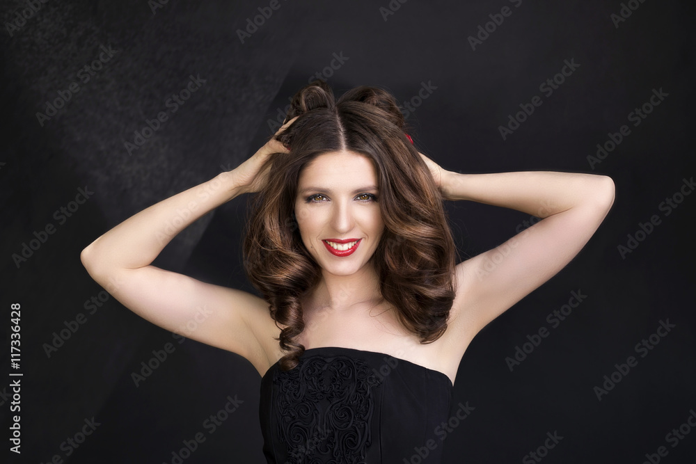 Portrait of beautiful woman in black dress with curly hair - isolated on black background. Portrait of beautiful woman in black dress with curly hair - isolated on black background.
