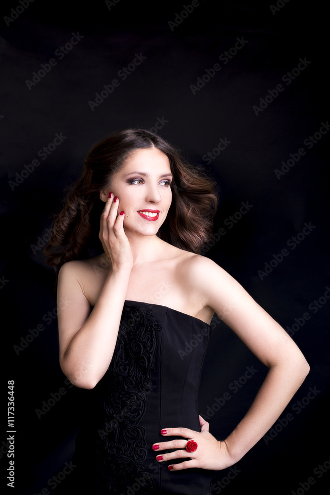 Portrait of beautiful woman in black dress with curly hair - isolated on black background. Portrait of beautiful woman in black dress with curly hair - isolated on black background.