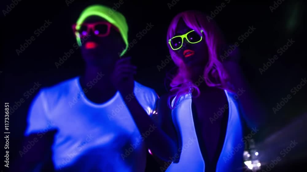cyber raver couple in fluorescent UV glow cyber raver couple in fluorescent UV glow