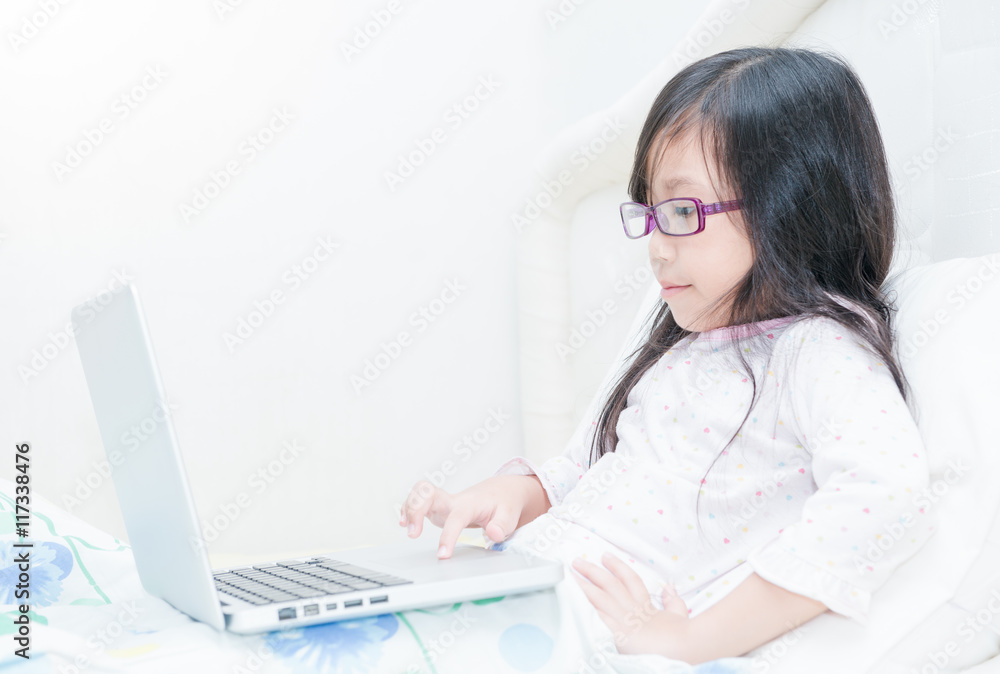Cute girl working on laptop computer concept for education Cute girl working on laptop computer concept for education
